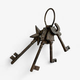Close-up of cast iron key set showing star charm, hook key, and hardware details with patina