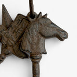 Profile of cast iron horse head detail showing ornate features and aged patina finish