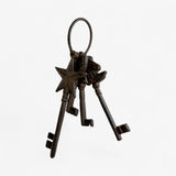 Full key ring with cast iron star charm, multiple vintage-style skeleton keys, and loop hanger
