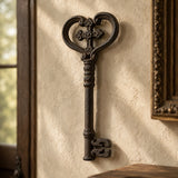 Angled view of ornate cast iron skeleton key wall hanging with heart-shaped bow