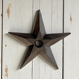 Rustic cast iron star wall decor with dark patina finish, vintage western accent on white shiplap