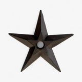 Dark cast iron star ornament with textured finish, centered hole for hanging, 3D dimensional design