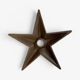 Cast iron wall star with dark finish, sculptural form with pointed edges and center mounting hole