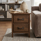 Cast iron drawer pulls on a wooden nightstand beside a sofa and table lamp