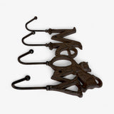 Cast iron cat hook organizer showing multiple curved hooks for hanging items