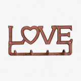 Rustic cast iron LOVE hook rack with cutout heart design and antique terracotta patina