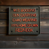 Cast iron Redneck Pride sign with mud bogging gun carrying camo wearing text, orange lettering