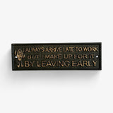 Cast iron rustic funny work sign with embossed text and distressed dark finish detail