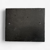 Aged cast iron home decor sign back view with weathered dark finish texture