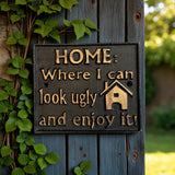 Black cast iron home sign with gold text Where I can look ugly and enjoy it on wooden fence