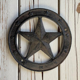 Rustic cast iron star badge wall decor with weathered black finish on white shiplap