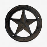 Cast iron star badge showing detailed metallic texture, dark charcoal finish with mounting holes