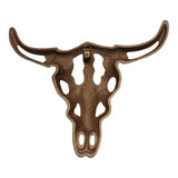Decorative cast iron bull skull viewed from front showcasing intricate carved features and bronze finish