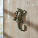 Cast iron gecko wall hook in green and gold finish with detailed texture and curved design