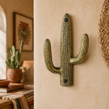 Weathered gold cast iron cactus wall hook with two rounded arms.