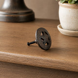 Side view of black cast iron wagon wheel cabinet knob with mounting screw