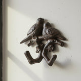 Rustic cast iron birds wall hook with detailed feather finish and curved legs for organizing