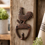 Cast iron rooster wall hook mounted on a rustic wood post.