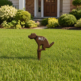 Cast iron No Pooping dog yard sign standing in a lawn.