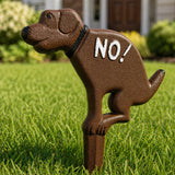 Close-up of a cast iron No Pooping dog yard sign with stake.
