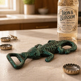 Close view of green cast iron alligator bottle opener on countertop.