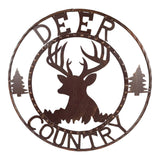 24 inch Deer Country metal wall sign circular cutout design with antler silhouette and evergreen trees on white