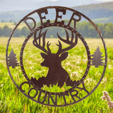 Rustic deer metal wall sign with country text and forest trees in 24-inch circular design, weathered brown finish
