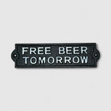 Black cast iron Free Beer Tomorrow plaque closeup, embossed white text, vintage humor sign