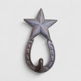 Cast iron star and horseshoe wall hook mounted on whitewashed wood, farmhouse western style