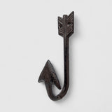Cast iron arrow wall hook with barbed arrowhead and feather-carved shaft, rustic dark patina