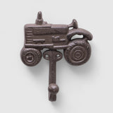 Vintage cast iron farm tractor wall hook with rustic brown patina displayed indoors