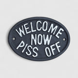 Black cast iron humorous welcome plaque with white raised lettering, rustic farmhouse decor