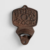 Rustic brown cast iron beer o clock bottle opener, full view on white background