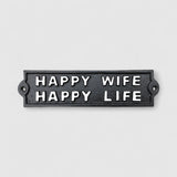 Black cast iron Happy Wife Happy Life sign detail, raised white lettering, humorous plaque