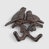 Dark brown patina cast iron dual birds on branch hook with natural weathered texture