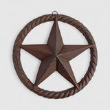Distressed cast iron star ornament with rope texture ring and weathered reddish-brown patina