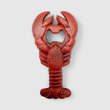 Cast iron lobster opener side profile showing textured red finish and claw detail