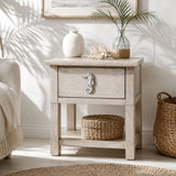 Coastal nightstand with distressed white seahorse cabinet knob and woven decor