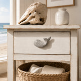 White whale drawer knob on a distressed coastal nightstand drawer