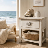 Coastal nightstand with white whale drawer knob, ocean view, and woven basket