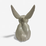 Cream-colored cast iron bunny statue from above displaying full body with realistic ear positioning