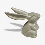 Cream cast iron bunny statue from rear view showing smooth rounded finish and sculptural form