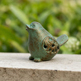 Mint green cast iron bird figurine with verdigris finish on a garden ledge, SKU GB78055