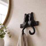 Close view of two black cast iron cat silhouettes above double hooks, SKU GB78064