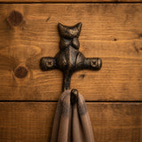 Close view of dark bronze cast iron cat hook holding a scarf, SKU GB78065