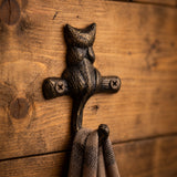 Antique bronze cast iron cat wall hook mounted on wood with visible screws, SKU GB78065