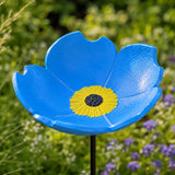 Blue cast iron flower bird feeder and bath with yellow center detail.