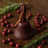 Burgundy cast iron dinner bell with leather strap, cranberries, and rosemary, SKU GB78097