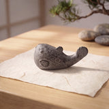 Side view of aged gray cast iron pufferfish paperweight with raised tail detail, SKU GB78104