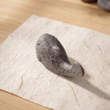 Close top view of aged gray cast iron pufferfish paperweight with mottled finish, SKU GB78104